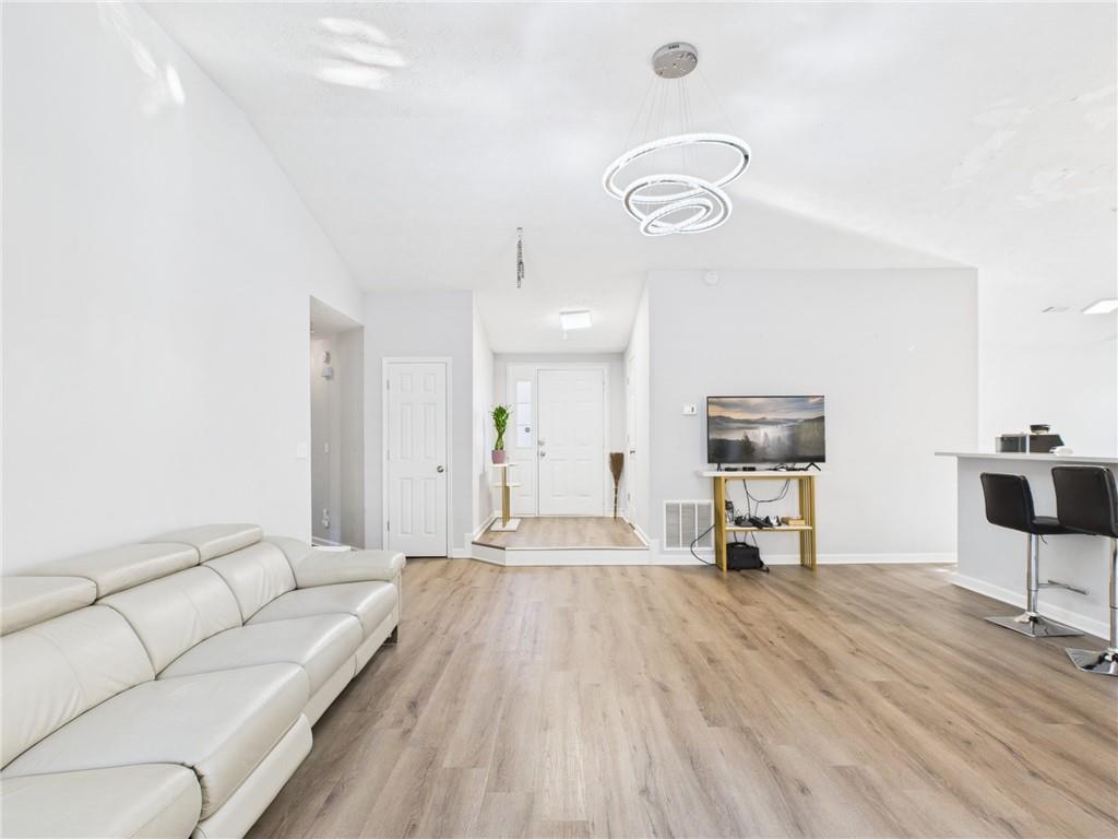 4060 Brooks Bridge Crossing Alpharetta, GA 30022 - Photo 6 of 30 a living room with furniture and a flat screen tv