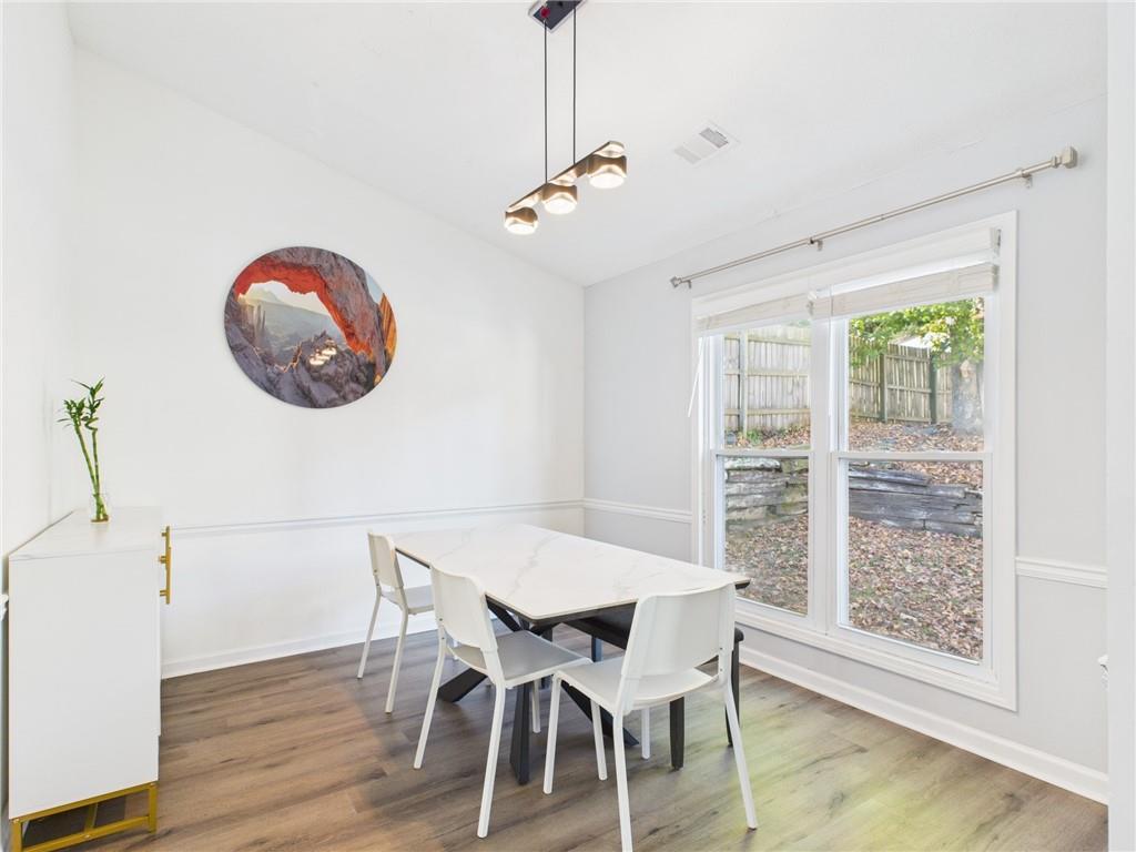 4060 Brooks Bridge Crossing Alpharetta, GA 30022 - Photo 8 of 30 a view of a dining room with furniture and wooden floor