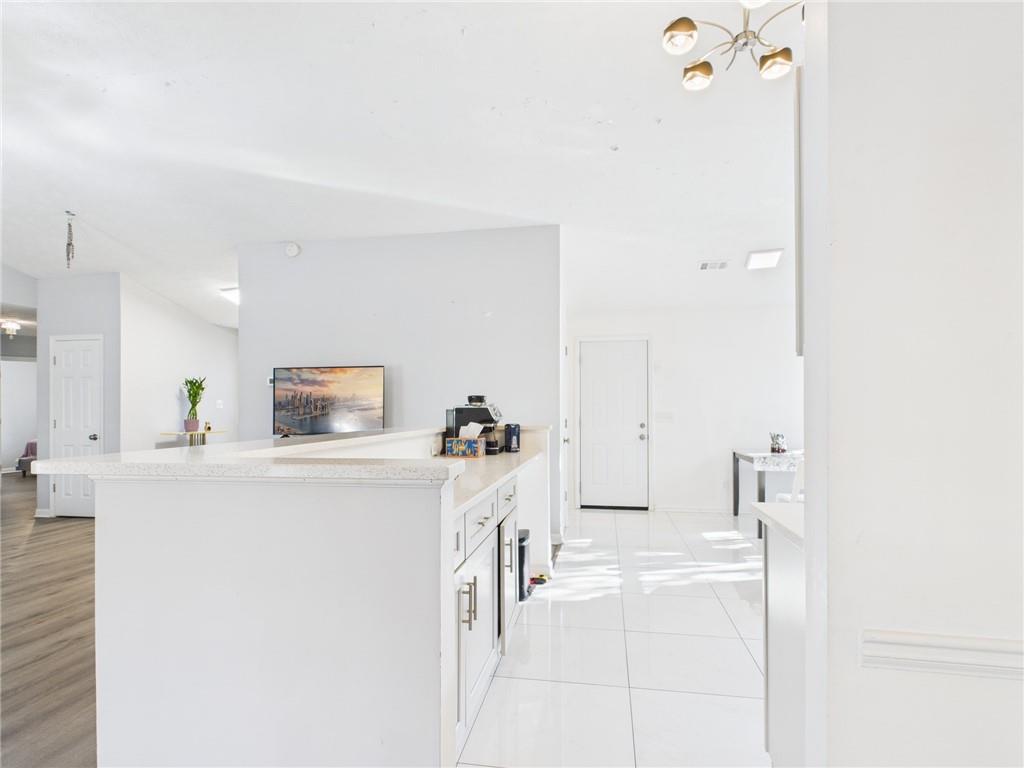 4060 Brooks Bridge Crossing Alpharetta, GA 30022 - Photo 9 of 30 a living room with furniture and a flat screen tv