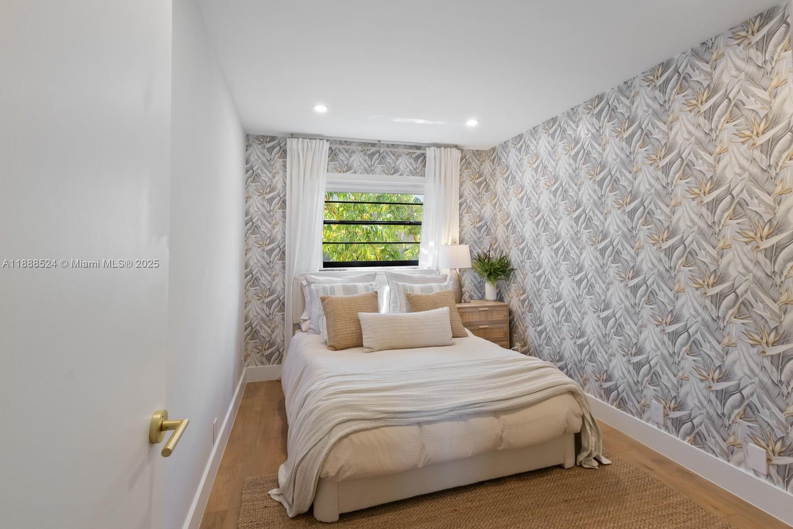 141 Crandon Boulevard, Unit 446 Key Biscayne, FL 33149 - Photo 15 of 30 a bedroom with a bed and a window