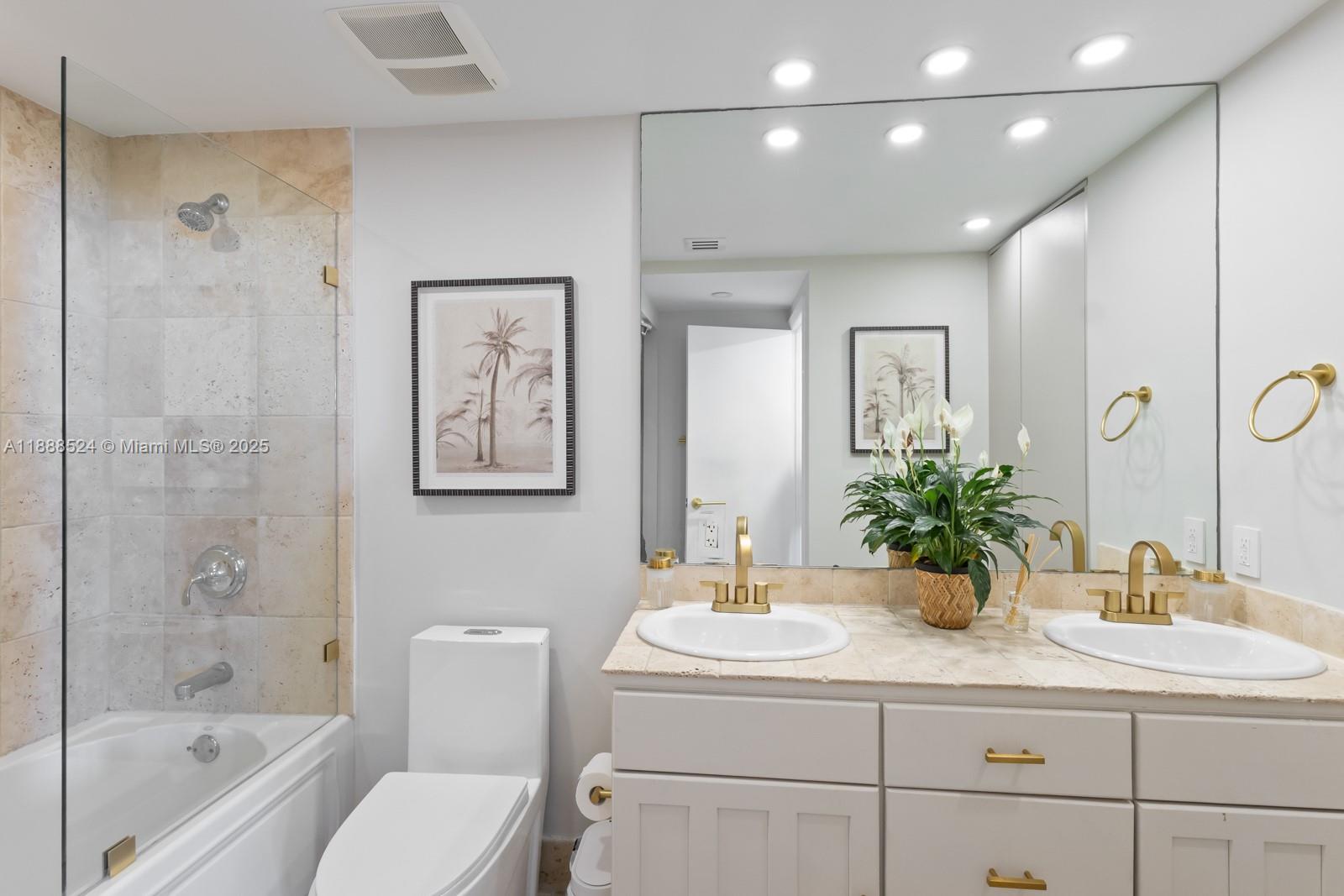 141 Crandon Boulevard, Unit 446 Key Biscayne, FL 33149 - Photo 18 of 30 a bathroom with a bathtub shower sink mirror and toilet