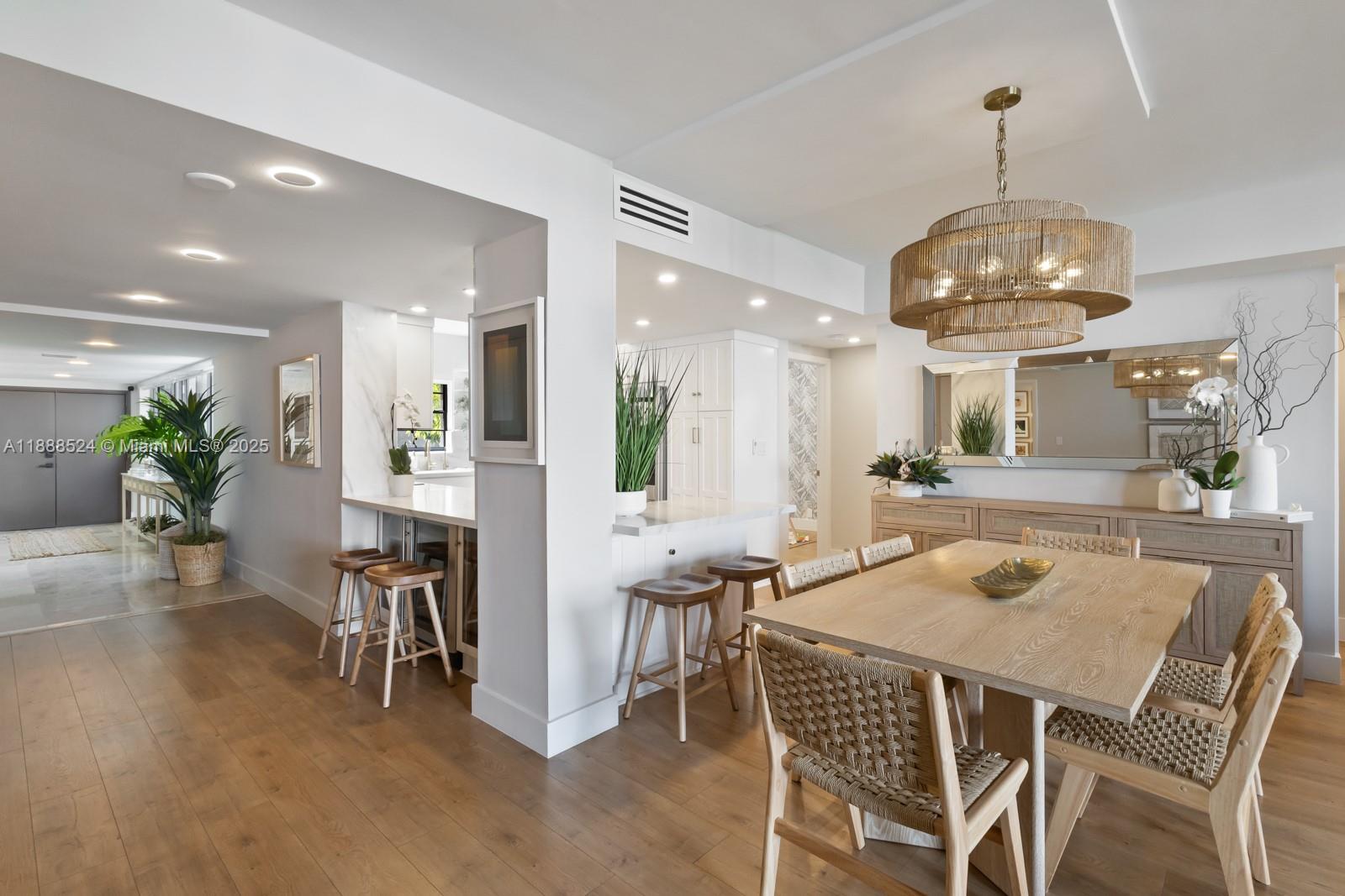 141 Crandon Boulevard, Unit 446 Key Biscayne, FL 33149 - Photo 3 of 30 a view of a dining room with furniture and wooden floor