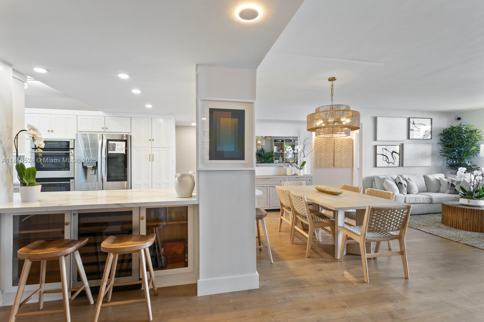 141 Crandon Boulevard, Unit 446 Key Biscayne, FL 33149 - Photo 6 of 30 a view of a dining room with furniture and chandelier
