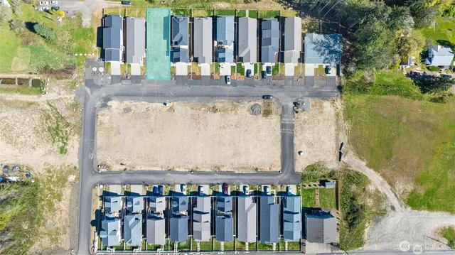 an aerial view of a house with swimming pool and ocean view