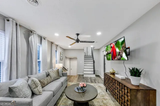 a living room with furniture and a large window