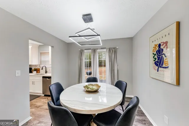 a view of a dining room with furniture and window