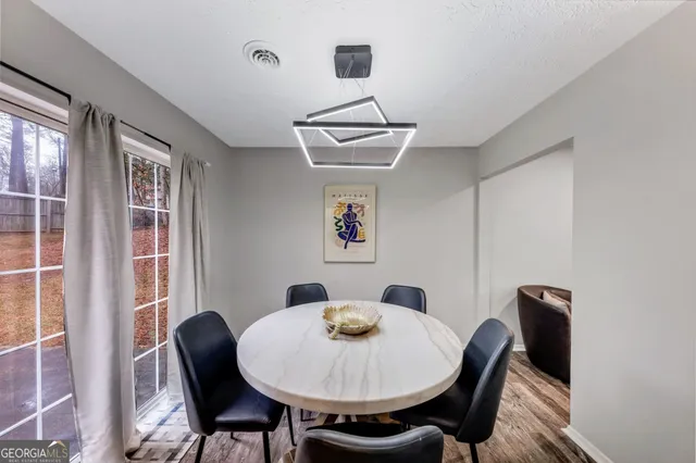 a view of a dining room with furniture and wooden floor