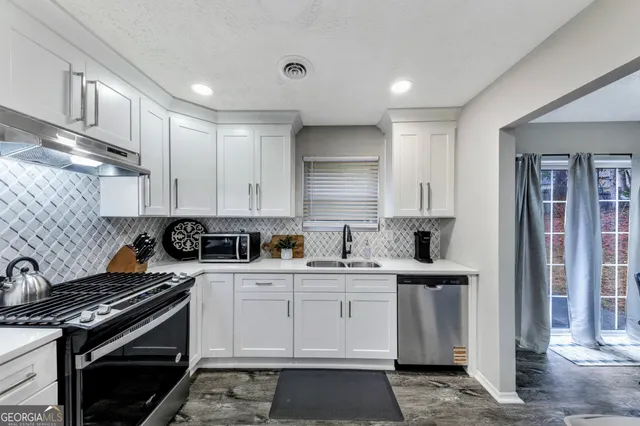 a kitchen with a sink stove and cabinets