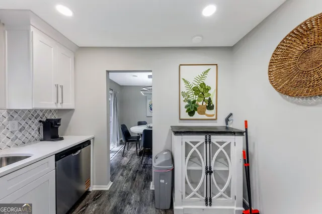 a view of entryway with furniture and a kitchen