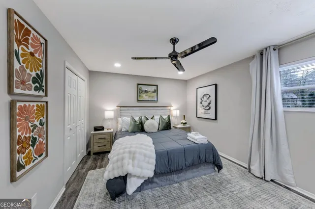 a bedroom with a large bed and a painting on the wall