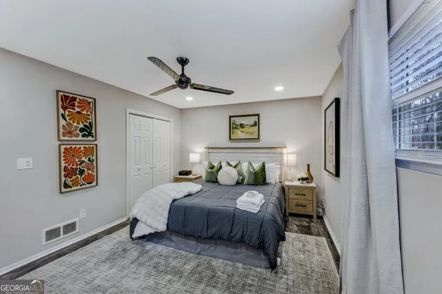 a bedroom with a bed and a painting on the wall