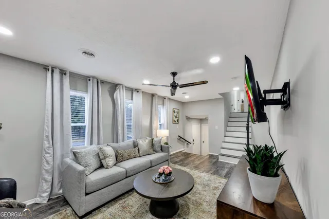 a living room with furniture and a large window