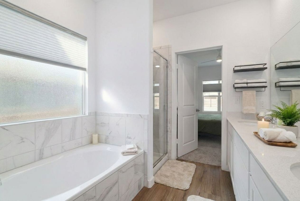 411 Jack Ryan Kyle, TX 78640 - Photo 14 of 30 a bathroom with a tub a sink and a large mirror