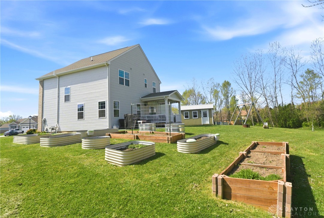 7900 Timberview Court Franklin, OH 45005 - Photo 51 of 60 This spacious backyard features a shed, raised garden beds, and a covered porch.