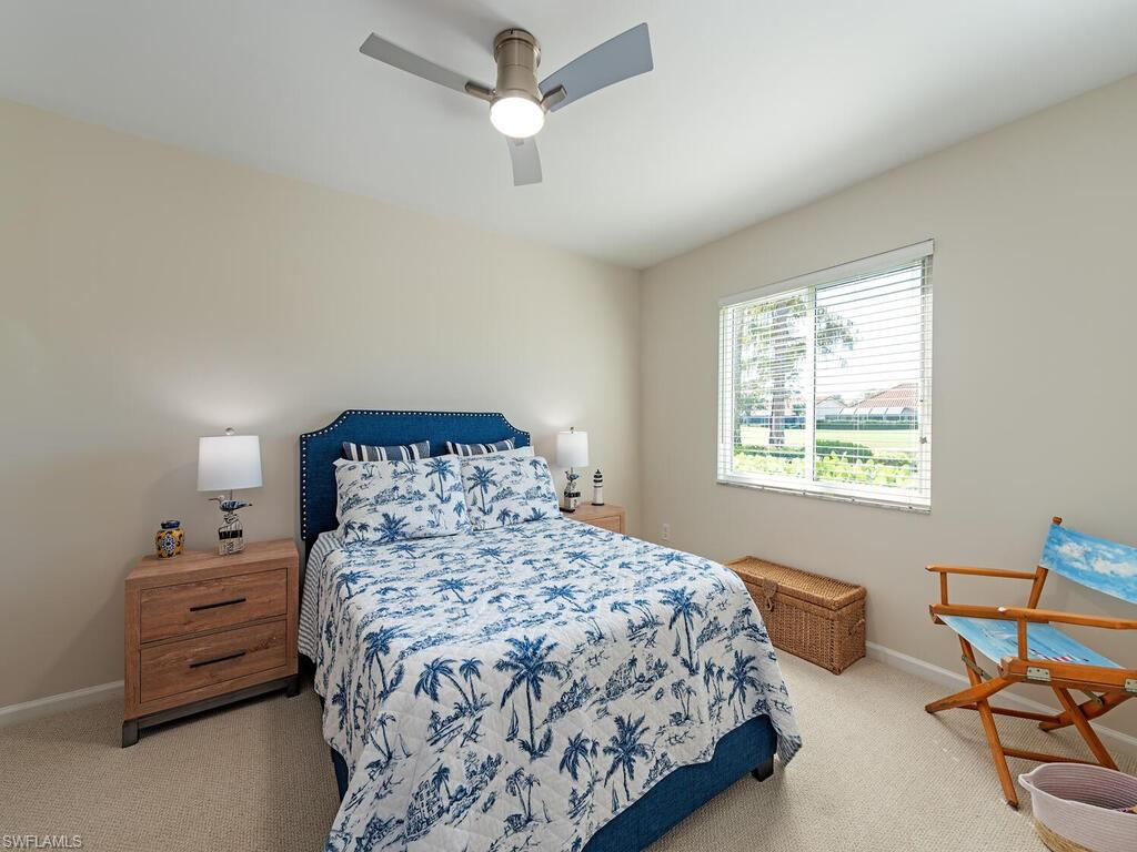 5950 Amherst Drive, Unit A106 Naples, FL 34112 - Photo 12 of 16 a bedroom with a bed and a window