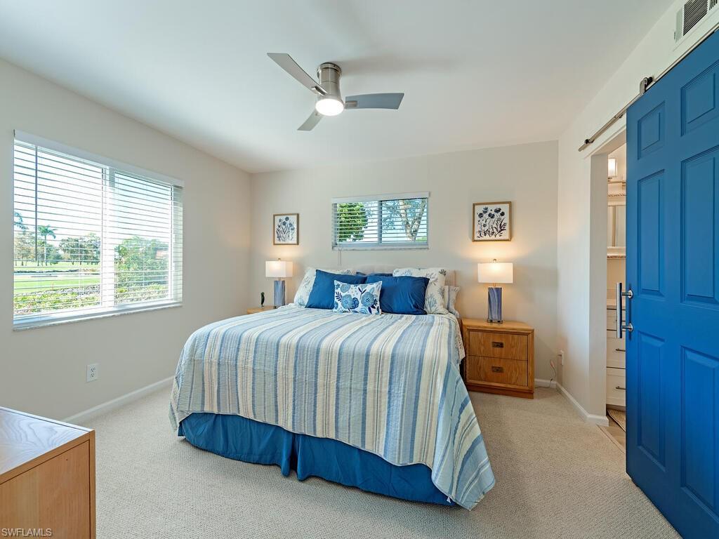 5950 Amherst Drive, Unit A106 Naples, FL 34112 - Photo 7 of 16 a bedroom with a bed and window