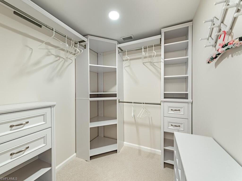 5950 Amherst Drive, Unit A106 Naples, FL 34112 - Photo 8 of 16 a view of walk in closet with empty racks