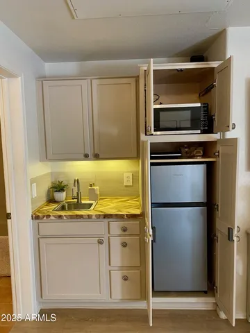 a kitchen with stainless steel appliances granite countertop a refrigerator and a stove