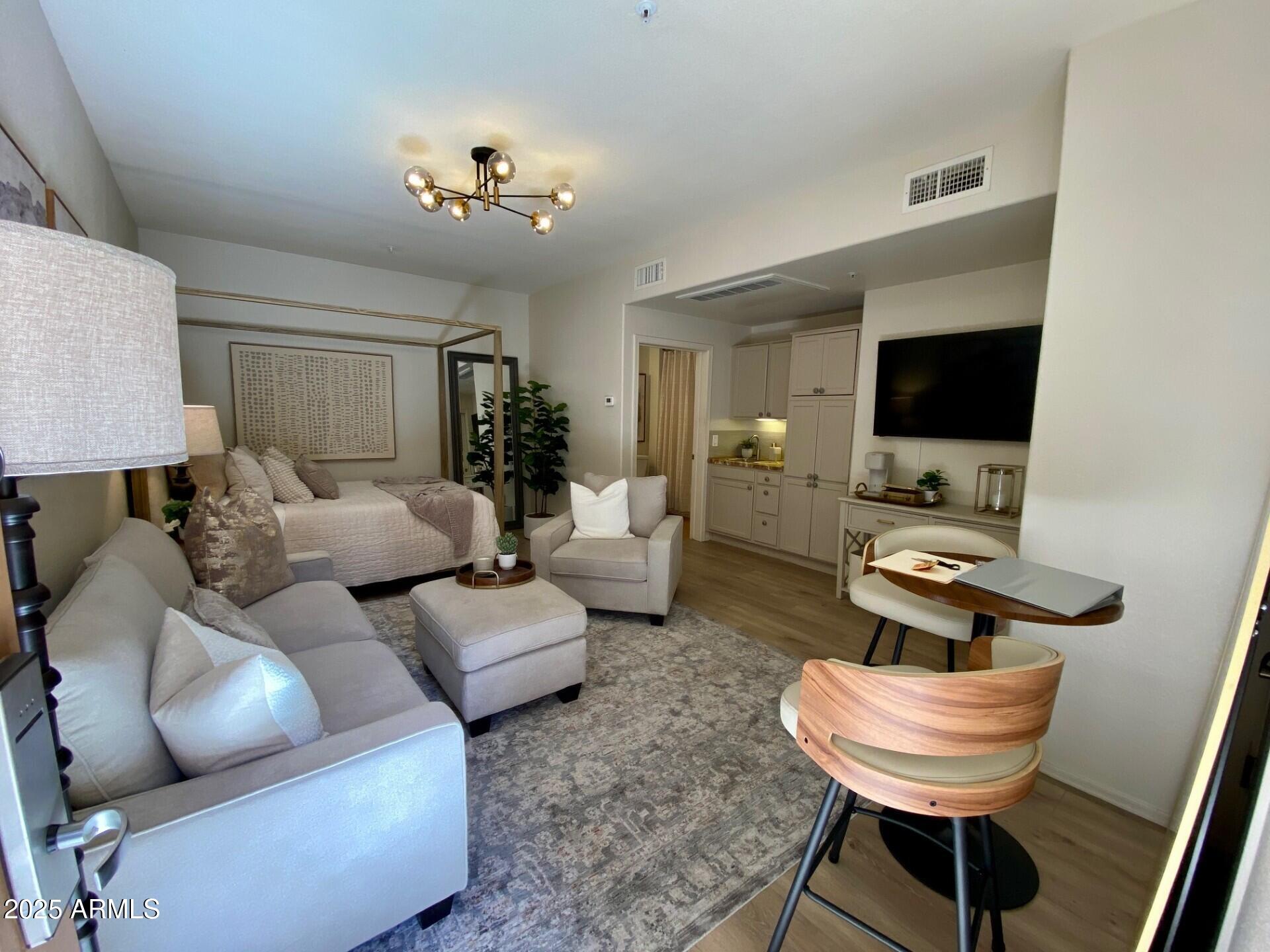16545 East Gunsight Drive East, Unit 112 Fountain Hills, AZ 85268 - Photo 5 of 9 a living room with furniture and a flat screen tv