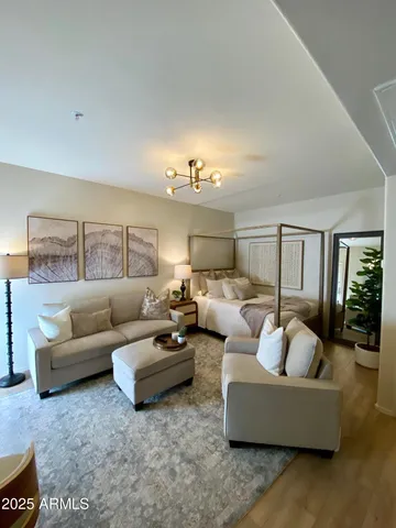 a living room with furniture and a chandelier