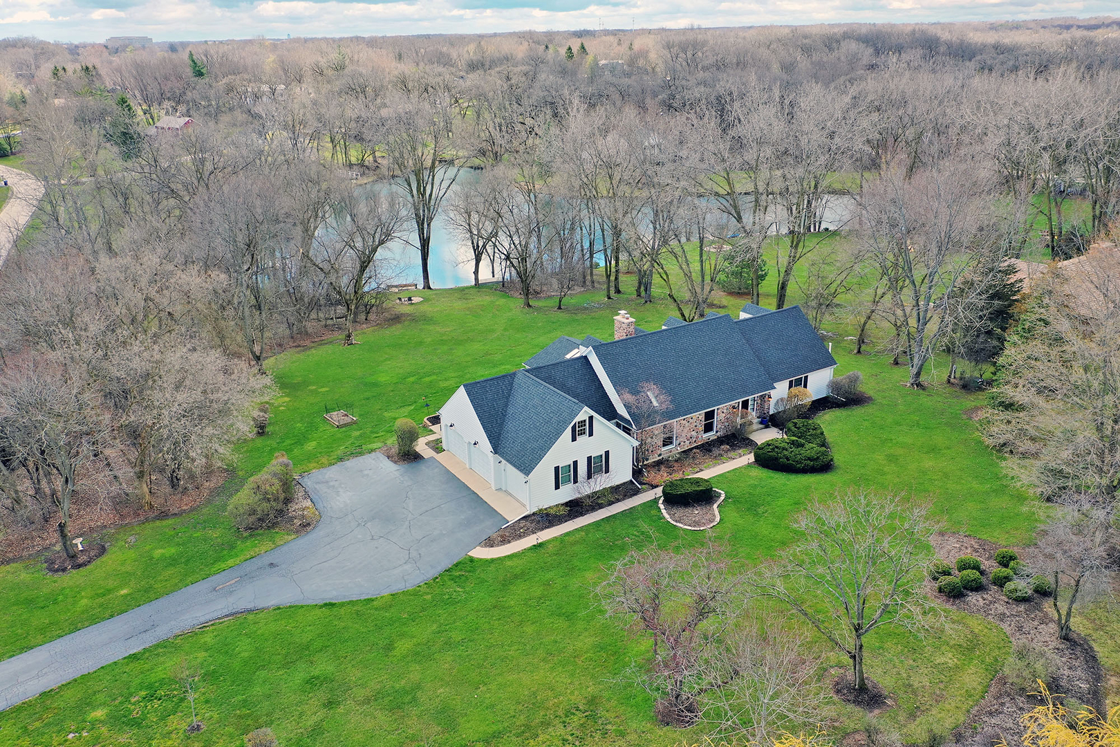 an aerial view of a house with backyard