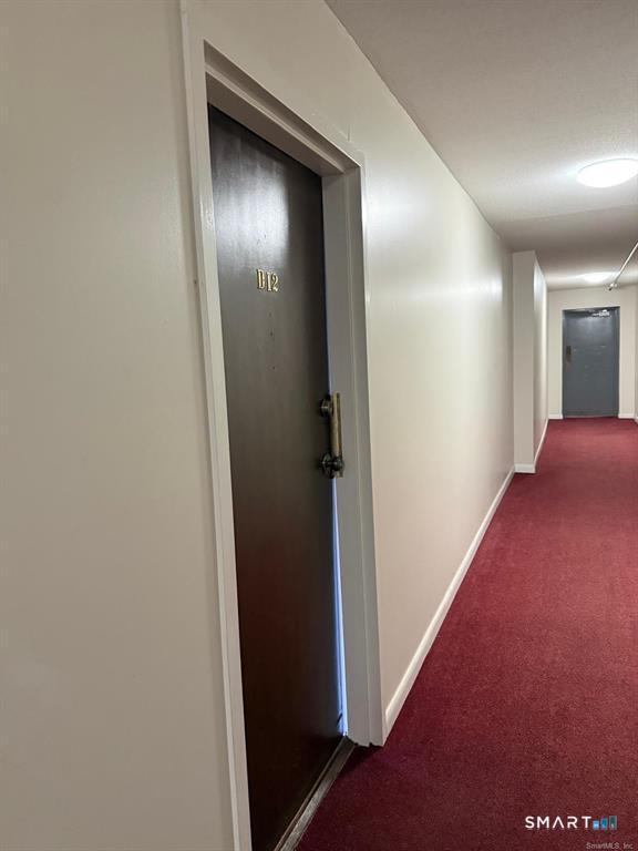 1274 East Main Street, Unit D12 Meriden, CT 06450 - Photo 2 of 14 a view of hallway with stairs
