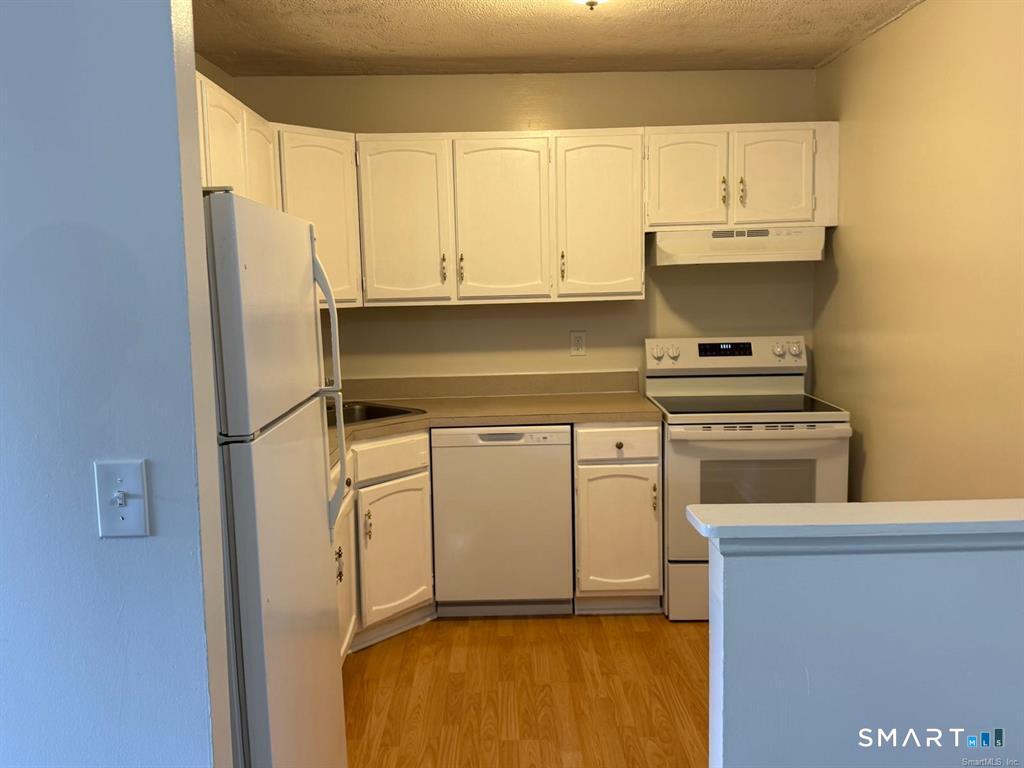 1274 East Main Street, Unit D12 Meriden, CT 06450 - Photo 7 of 14 a kitchen with cabinets and appliances