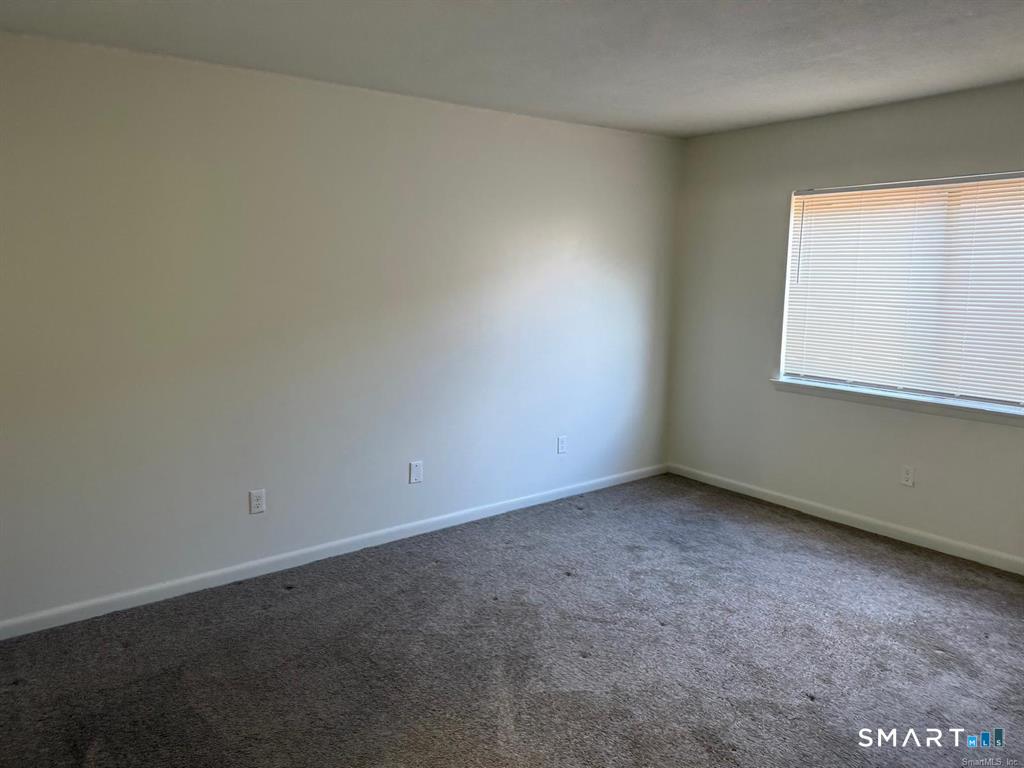 1274 East Main Street, Unit D12 Meriden, CT 06450 - Photo 8 of 14 an empty room with a window