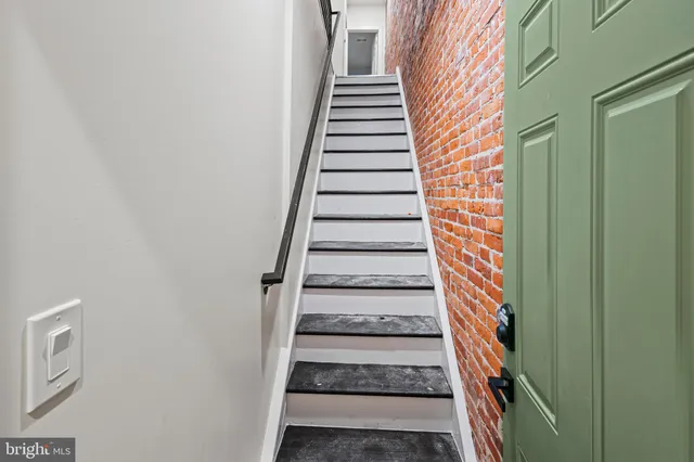 a view of a staircase with white walls