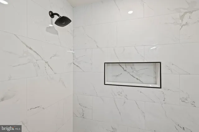 an empty room with wooden floor and glass door