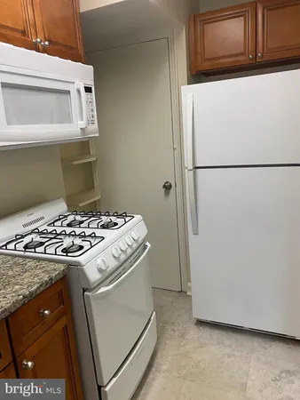 a stove top oven sitting inside of a kitchen