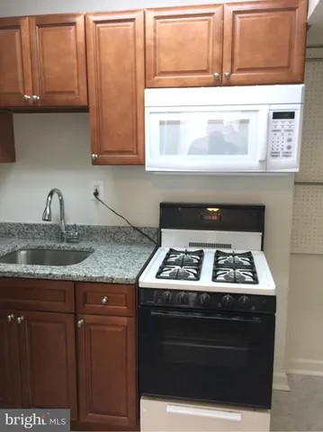 a stove top oven sitting inside of a kitchen