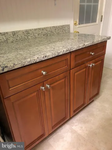 a kitchen with granite countertop cabinets and sink