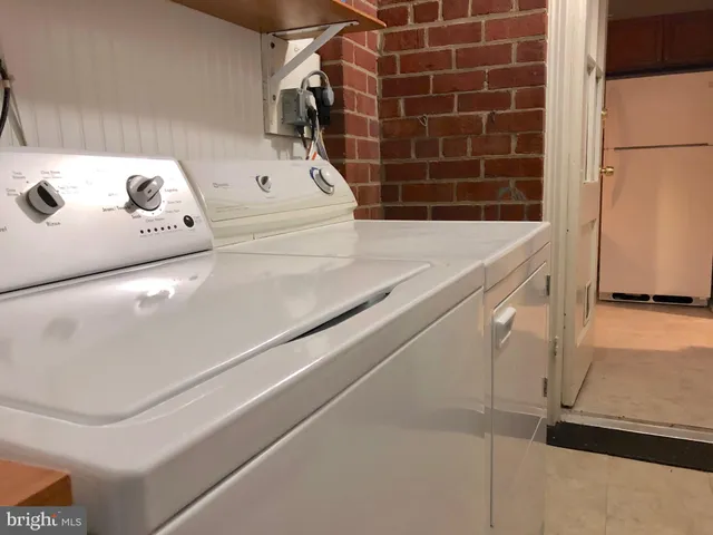 a view of bathroom with tub and shower