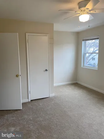 an empty room with windows and closet