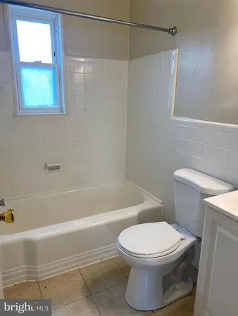 a bathroom with a toilet and a bath tub
