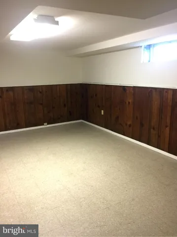 a view of an empty room with wooden walls