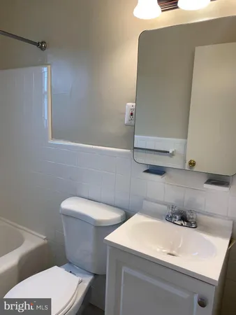 a bathroom with a sink a toilet and vanity