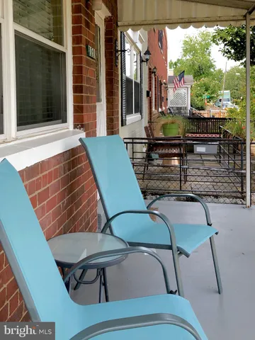 a view of a patio with table and chairs