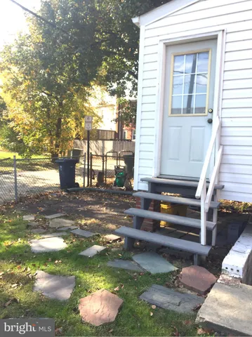 a backyard of a house with barbeque oven