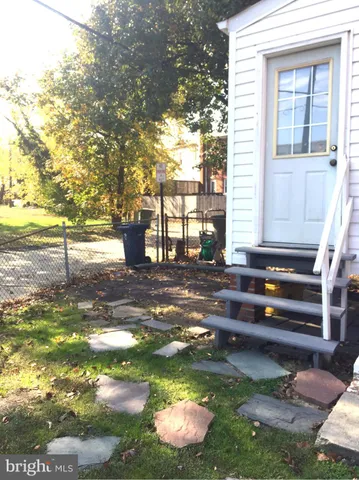 a backyard of a house with barbeque oven