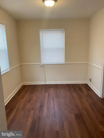 a view of a room with wooden floor and window