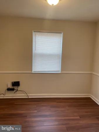a view of a small space with wooden floor and a window