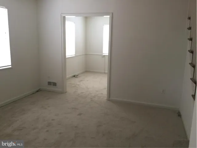 an empty room with a empty space and window