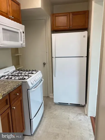 a kitchen with a refrigerator and a stove