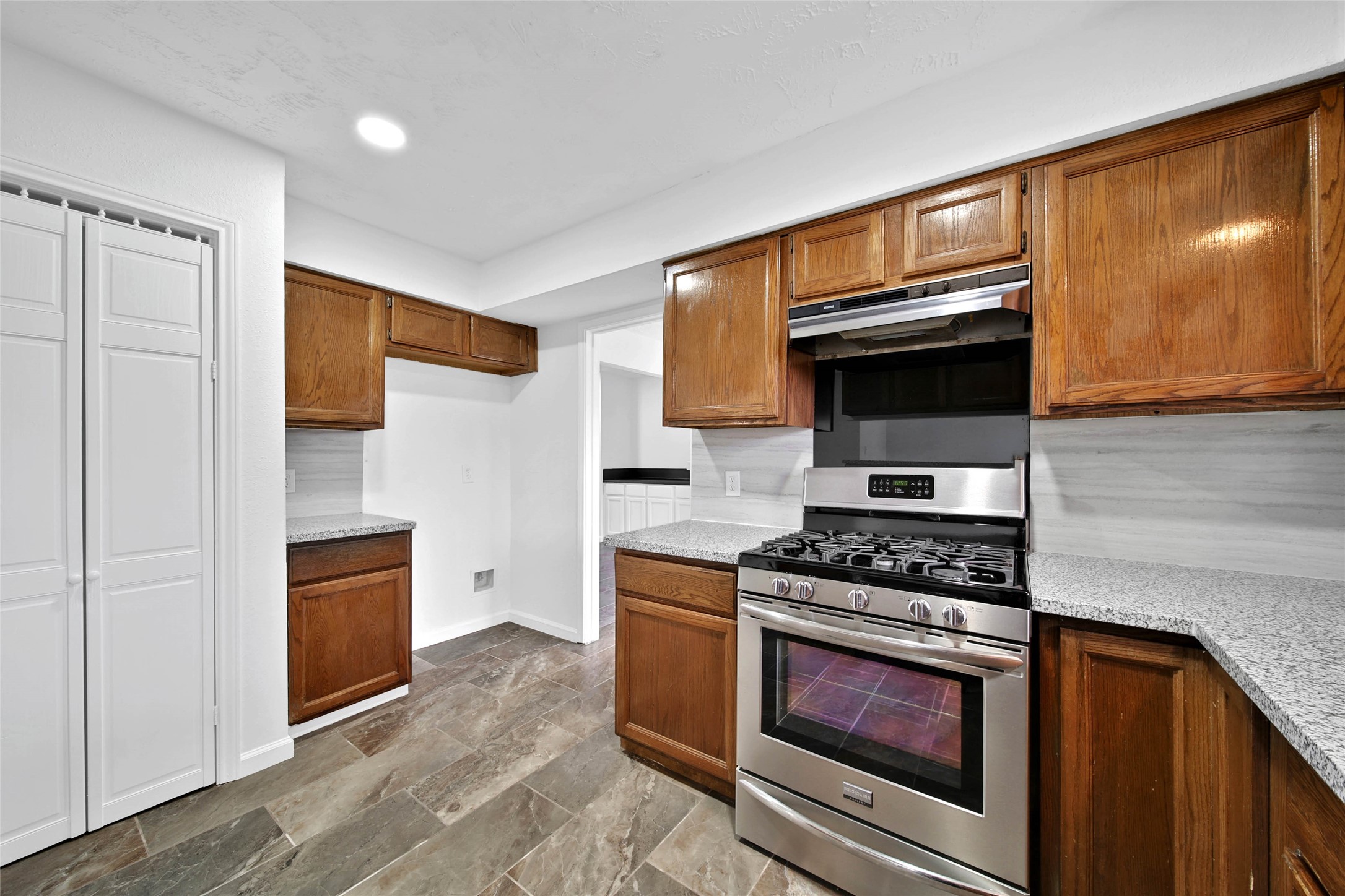 22214 Meadowhill Drive Spring, TX 77389 - Photo 5 of 13 a kitchen with stainless steel appliances a stove and a microwave