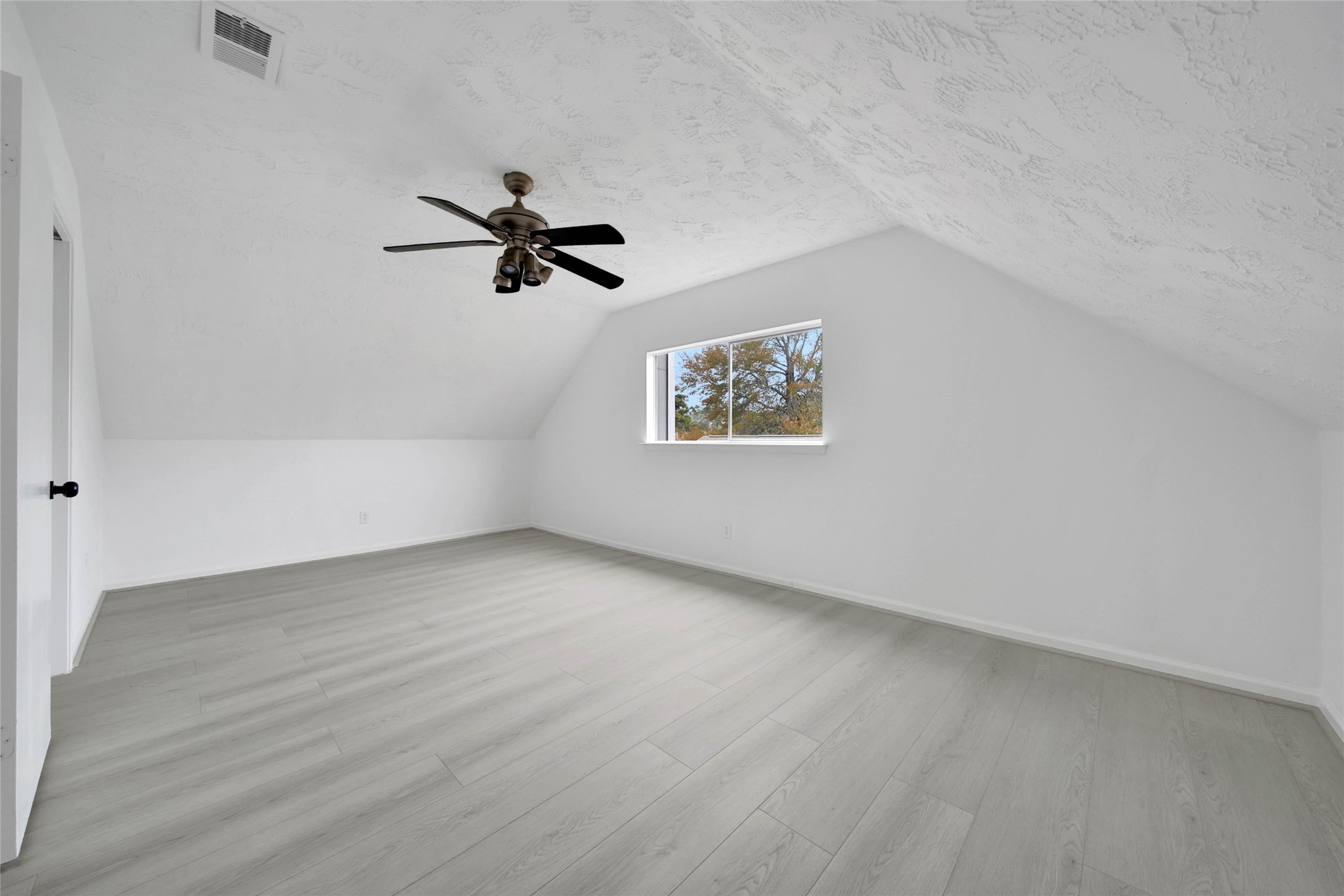 22214 Meadowhill Drive Spring, TX 77389 - Photo 9 of 13 an empty room with a window and a ceiling fan