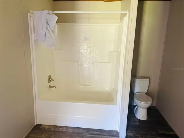 a bathroom with a bathtub and toilet