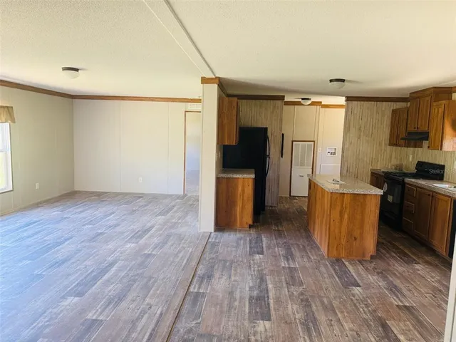 a view of a kitchen with furniture and wooden floor