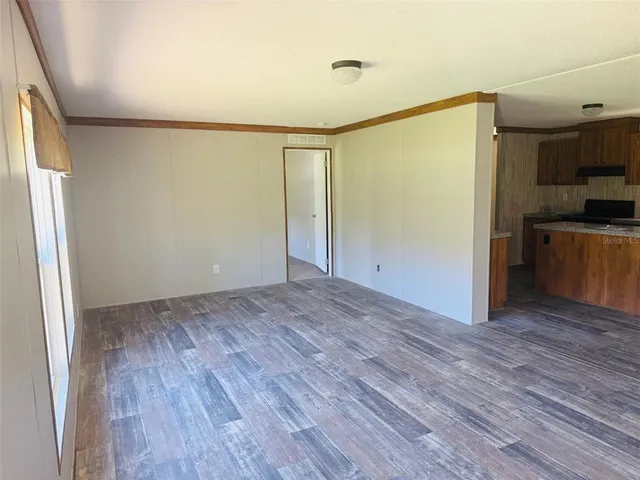 a view of a kitchen with wooden floor and a sink